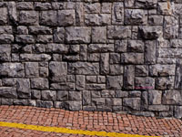 old stone wall with brick walkway