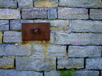 rusted metal plate on vintage stone wall
