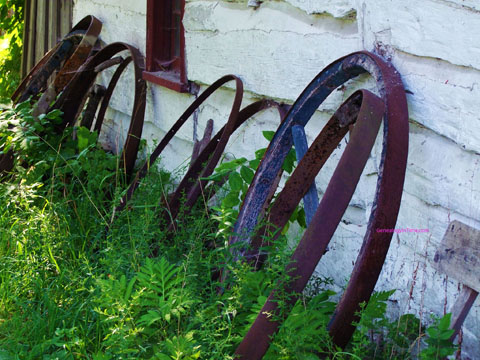 wagon wheels against side of building